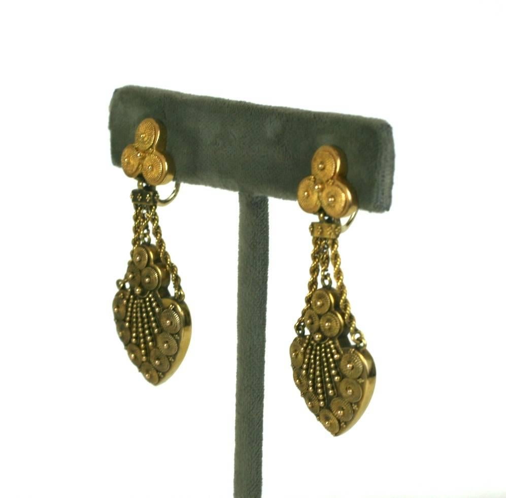 Wonderfully elegant Victorian Etruscan earrings from the late 19th Century in 14k gold. Intricate swirls and gold shot and bead work decorate the face. Beautiful gold work and craftsmanship. Exquisite quality and weight. Screw back fittings. 1870's