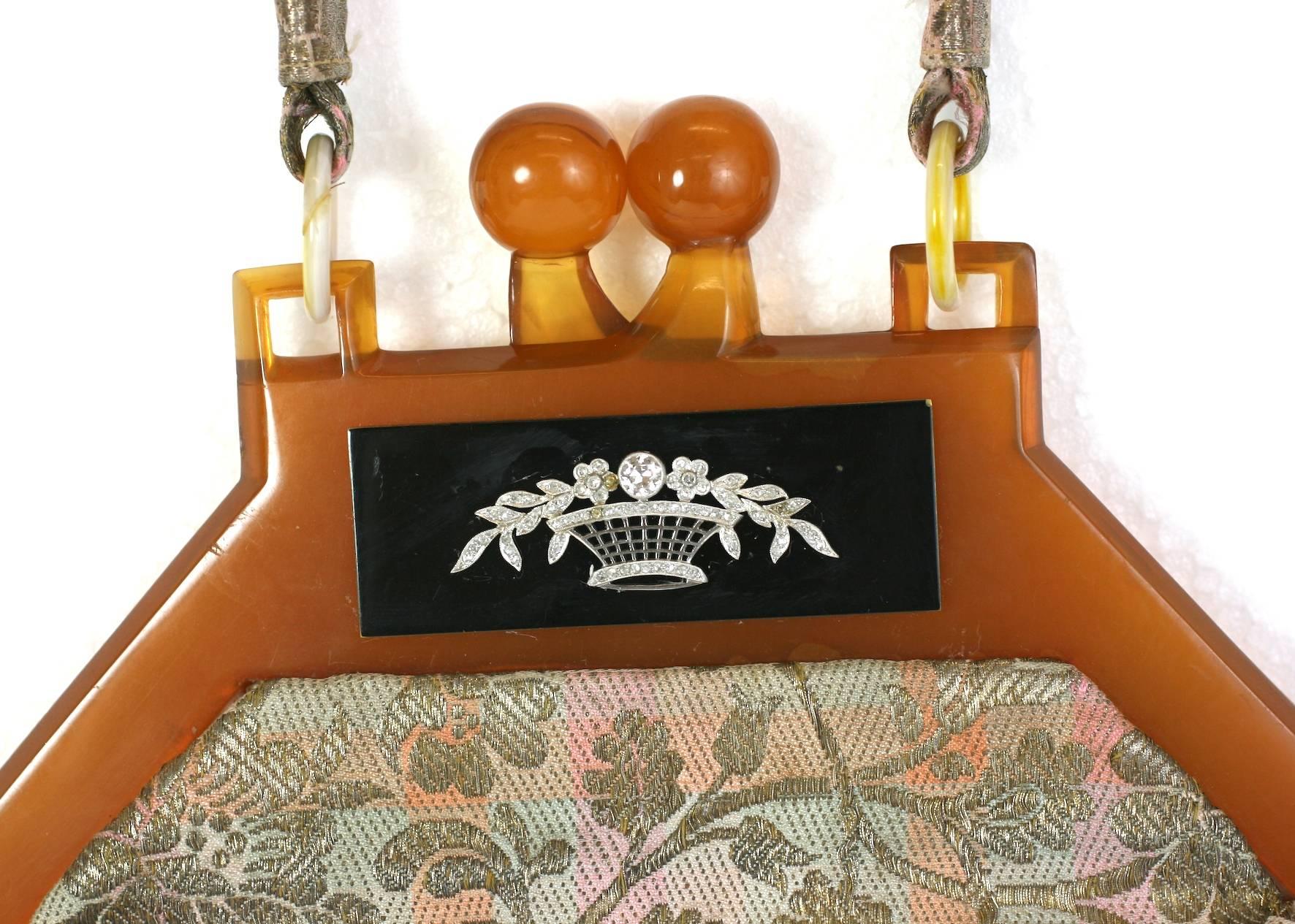 Custom Evening Bag made in the 1940's with a bakelite frame, adorned with a lovely Art Deco diamond basket on a French lame broche base.
The tortoise bakelite frame has a black bakelite panel insert decorated with an Art Deco diamond basket motif.