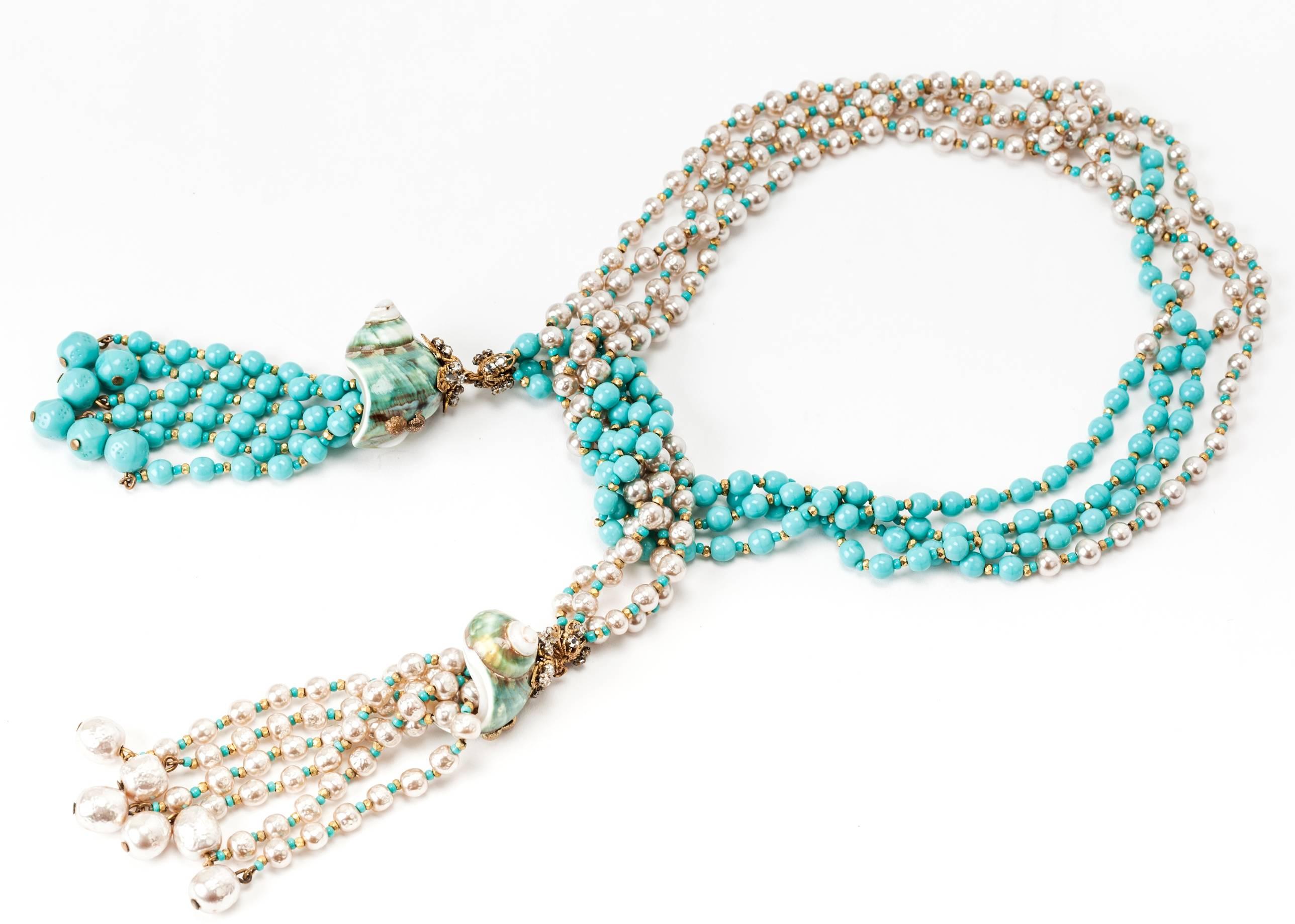 Wonderful, early and rare Miriam Haskell suite composed of a lariat, clip earrings and bracelet. 
Signature Haskell faux pearls are paired with turquoise pate de verre beads with Russian gilt metal and pave rose montee spacers. 
The 4 strand
