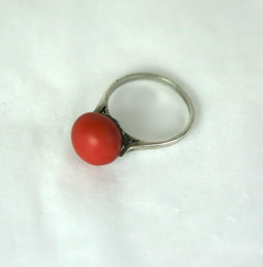 Elegant Art Deco Coral Cabochon Ring set in sterling silver. French silver hallmarks, from the Art Deco period. Fluted cup setting. 1930's France. Excellent condition. 
Size 5.5 US.  Natural coral cabochon 10mm. 