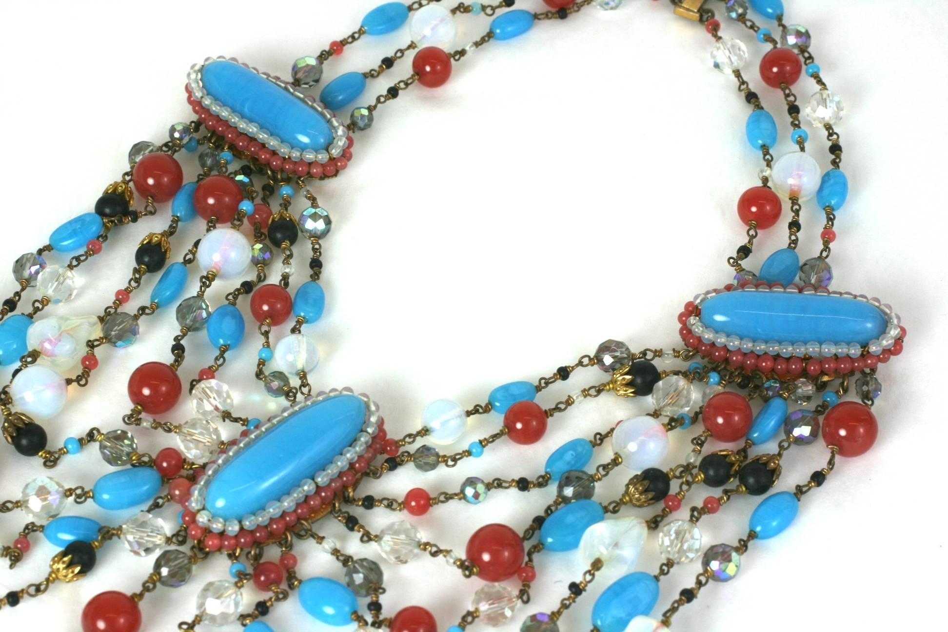 Extraordinary Louis Rousselet  draped bib necklace of dramatic pate de verre swags and hand sewn oval plaques in turquoise, opaline, carnelian, jet and aurora crystal hand made beads set in gilt metal. Handmade with slide clasp. France 1930's.