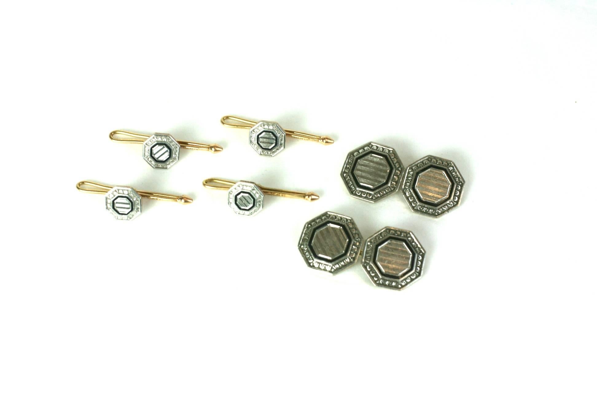 Elegant Art Deco Engraved and Enamel Stud Set from the 1930's. Set in 14k yellow gold with platinum tops and black enamel. Cuff links and 4 shirt studs included.
1930's USA. Excellent condition. 