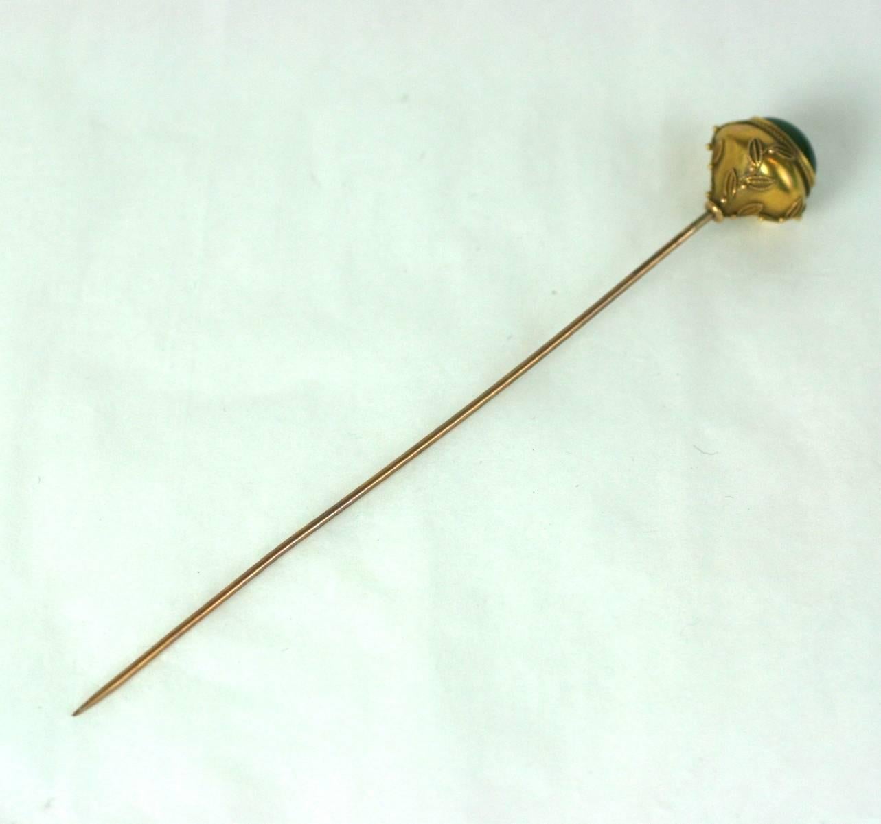 Victorian hat pin in the Aesthetic taste in 14 kt gold with deep green nephrite jade oval cabochon. The sides are decorated with Etruscan gold vine and berry decoration. Shaft is gold filled.  Excellent Condition. 1880's USA. 
L 5