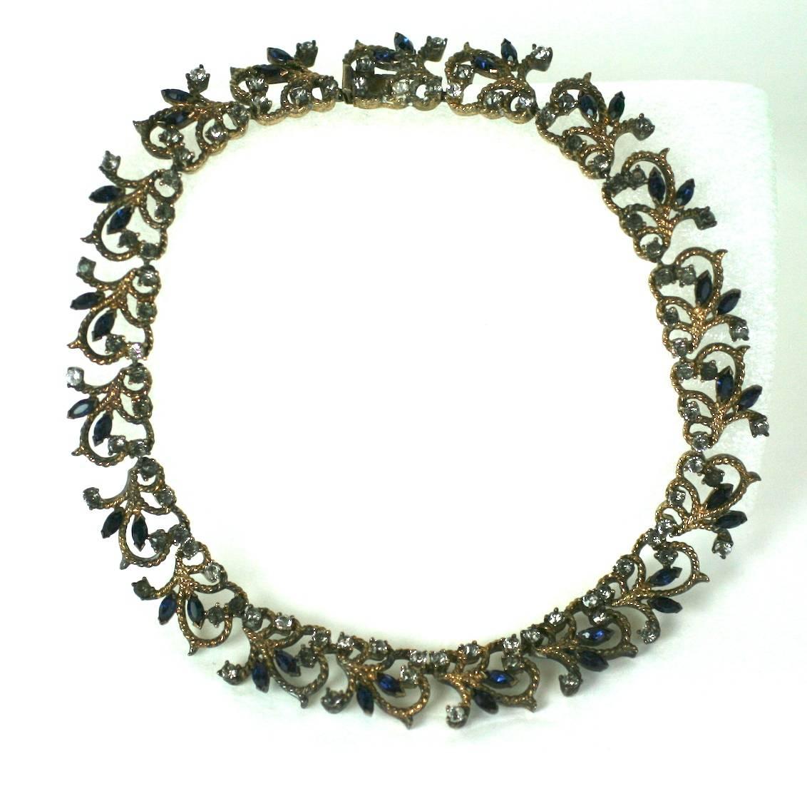 Elegant gilt sterling silver faux sapphire marquise and smoke grey crystal pave articulated collar necklace with vine and leaf motifs. 1940's USA. Excellent Condition.
Length 14.50