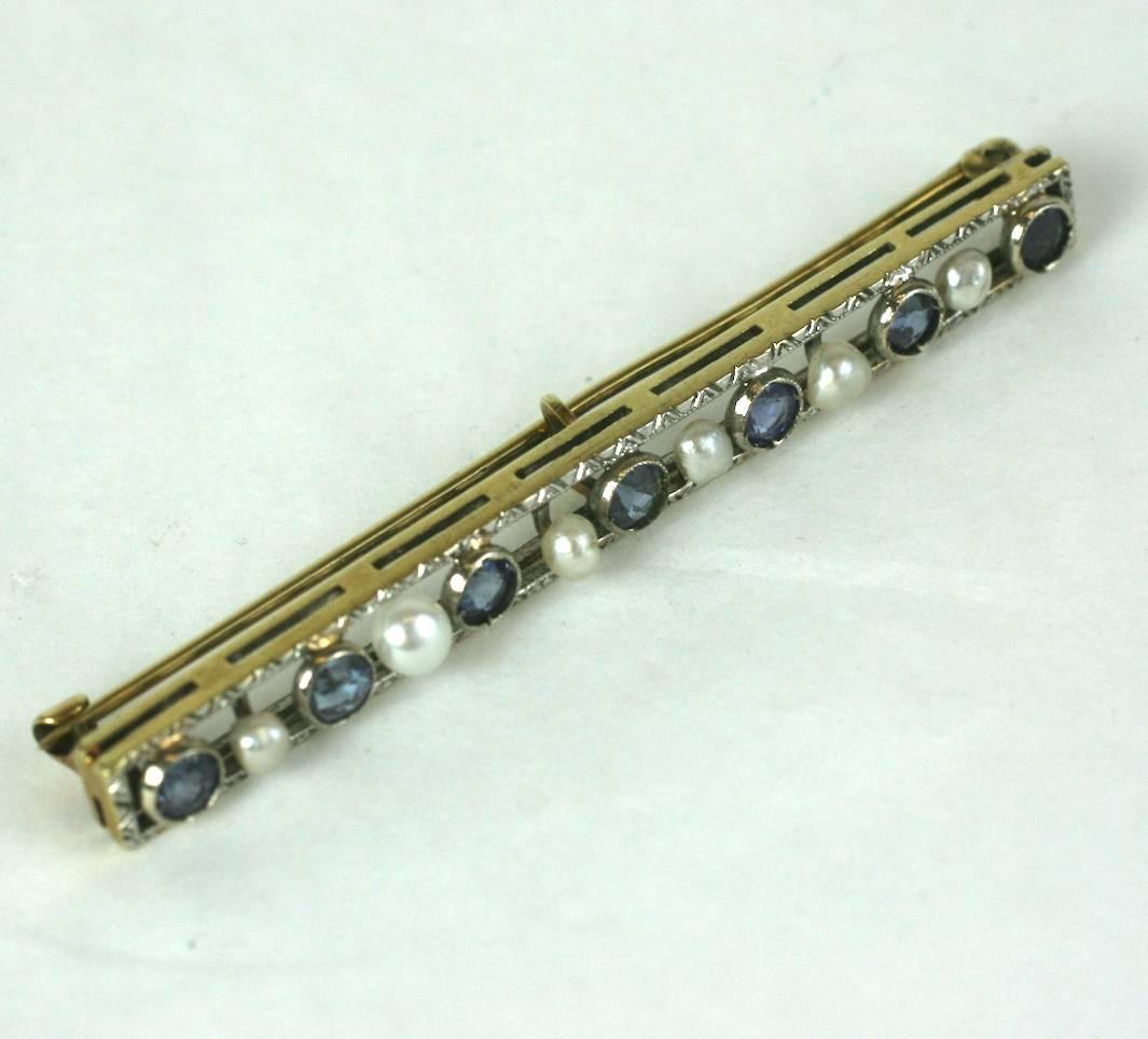 Lovely Edwardian Sapphire and natural pearl bar pin brooch of bezel set blue sapphires with pegged pearls. Set in 14k gold setting with a platinum top, with etched and incised decorations. 1910's USA.  3