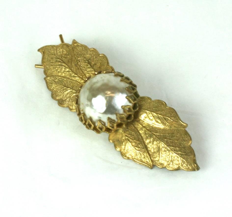 Miriam Haskell hair barette of signature Russian gilt filigree leaves with focal baroque faux pearl cabochon. 1950's USA. 
Excellent Condition.
L 2.50