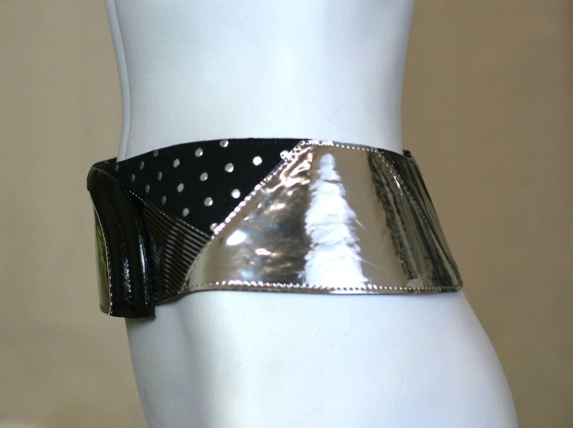 Krizia Pieced Metallic Hip Belt of synthetic and printed metallic leathers with quilted black leather end piece.
1980's Italy, Sized 44. Adjustable hooks in interior.  
Sits at base of waist on hips. 1980's Italy. 
Width 3