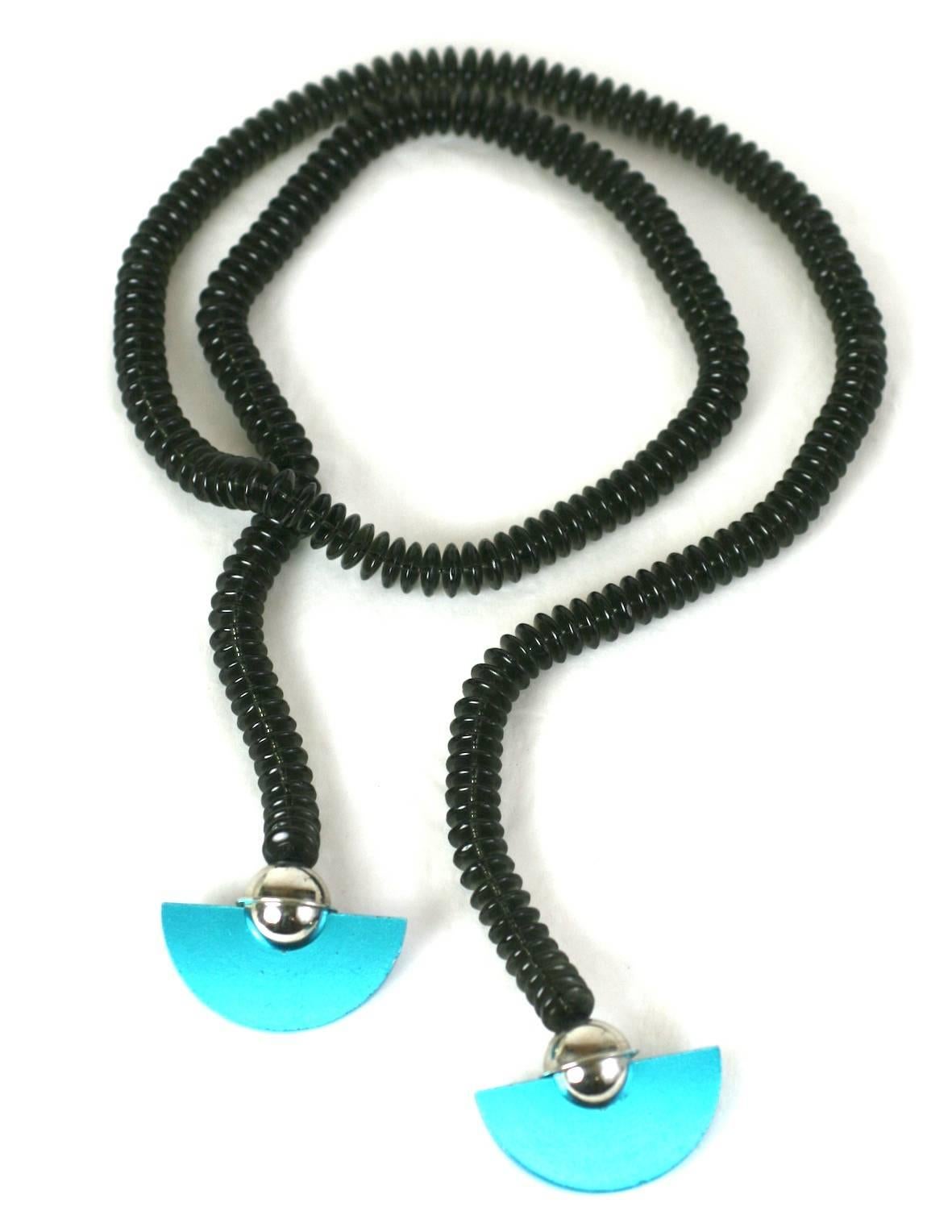 Unusually cool Post Modern Lariat with anodized aluminum half moon slices in rich iridescent blue mounted on chrome spheres. The necklace is composed of hundreds of smokey grey glass tablet beads which end in these striking drops. 
Can be worn in a