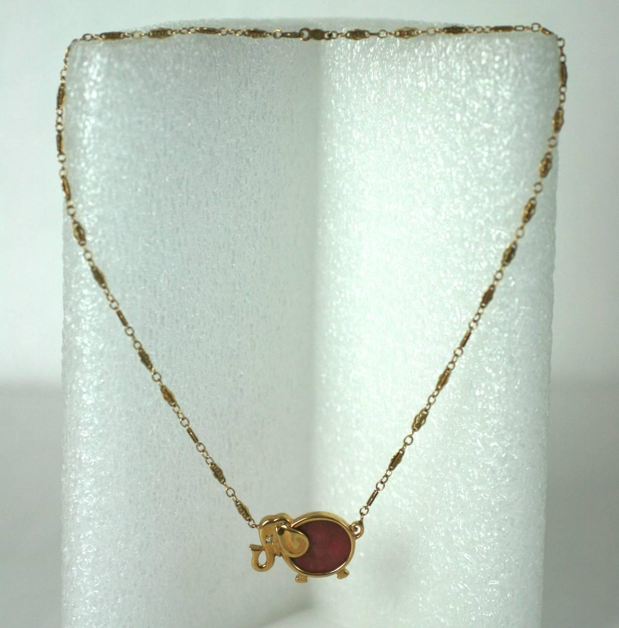 Charming Elephant pendant in 14k gold with deep pink rhodochrosite body with diamond chip eye. 1960's USA. 
Excellent Condition. 
L 14.75