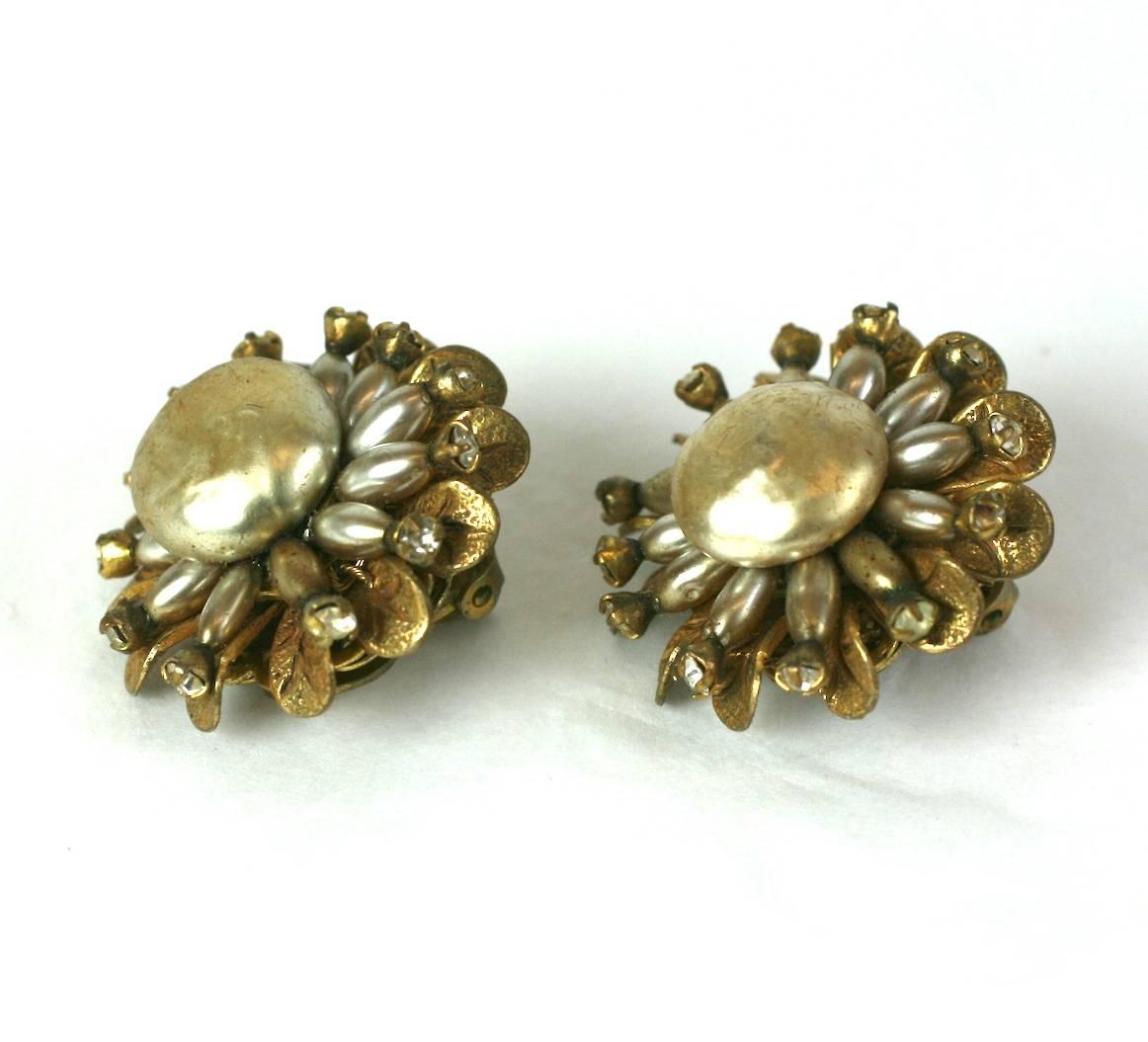 Mirian Haskell flower head earclips with pave set pegs holding small, faux rice pearls on a signature Russian gold petal base. 1940's USA. Excellent Condition. 
1.25