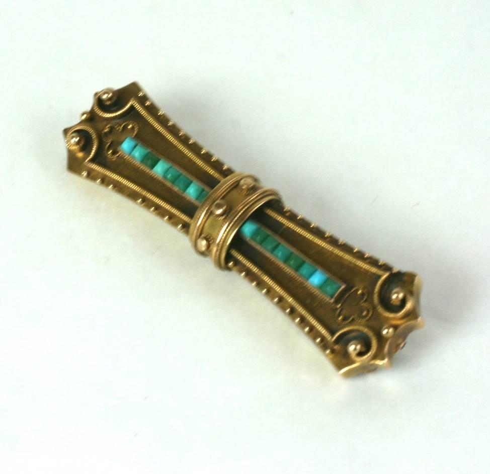 Victorian bar pin with calibre set turquoise in 14k gold. Nice Etruscan work decoration. 1880's USA. Excellent Condition. 
Length  2 3/16
