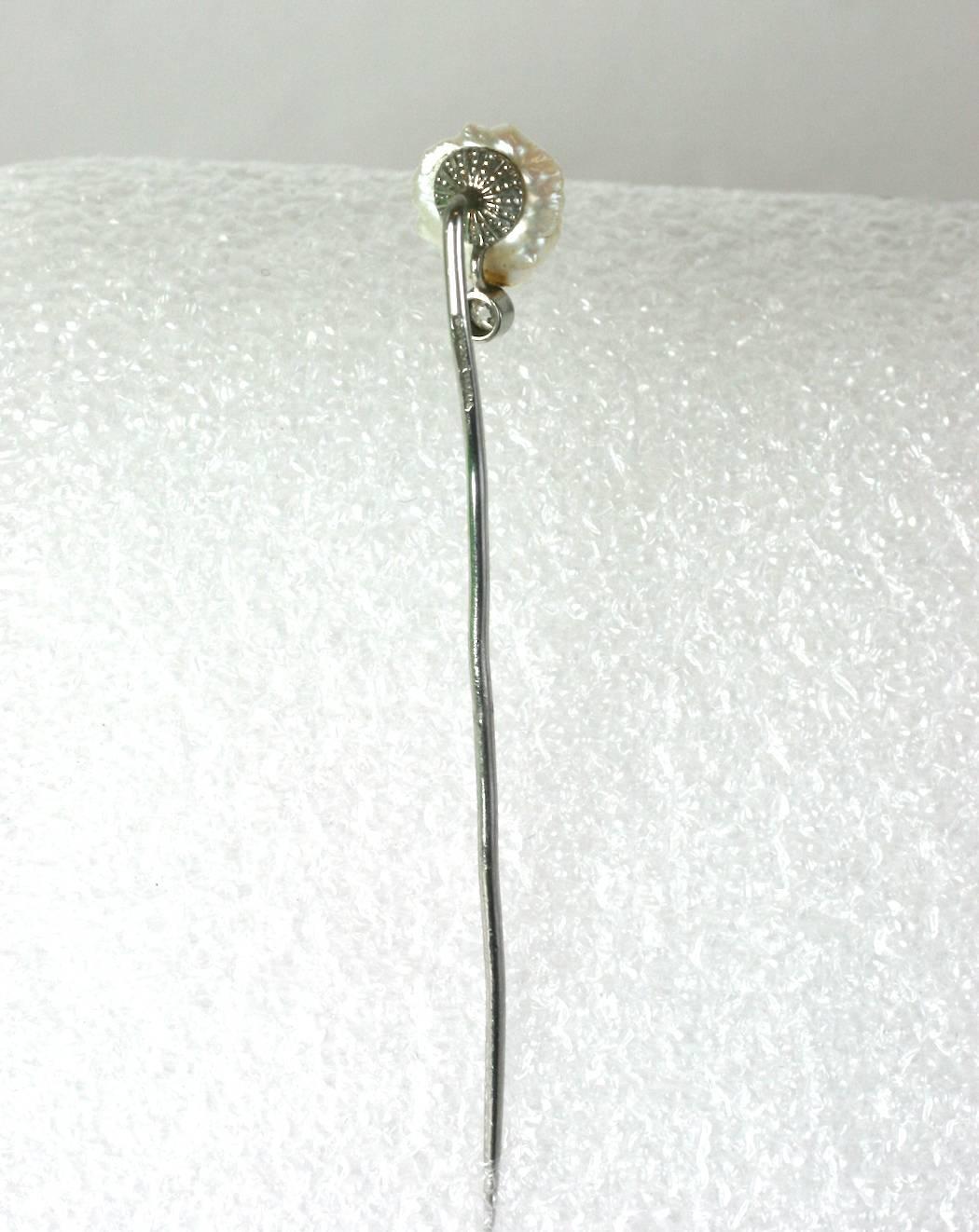 Elegant and early Tiffany platinum stickpin with large natural pearl and collet set diamond accent from the Edwardian period. Large 10 mm natural pearl (likely American as they preferred American natural resources whenever possible) set onto an