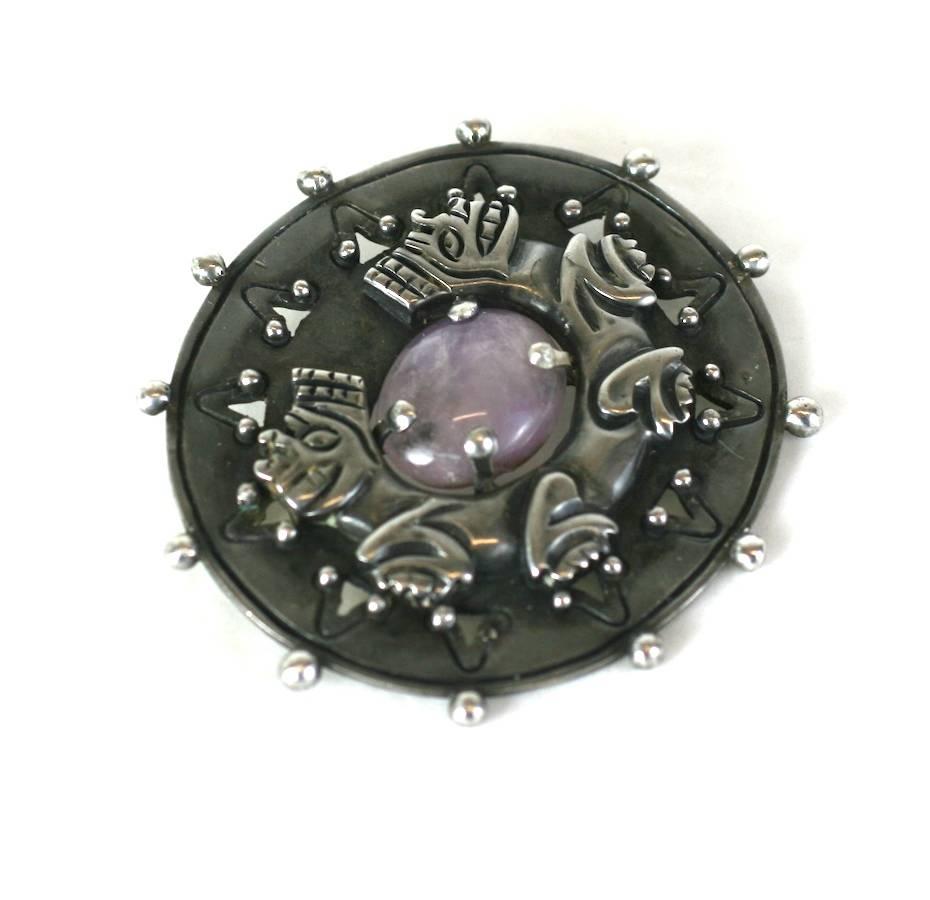 Early William Spratling brooch set with a pale cabochon amythest. A symbolic double headed animal is wrapped arround the stone. Silver balls decorate the edge of this heavy gauge sterling brooch, handmade in Mexico circa 1930's. Early Spratling