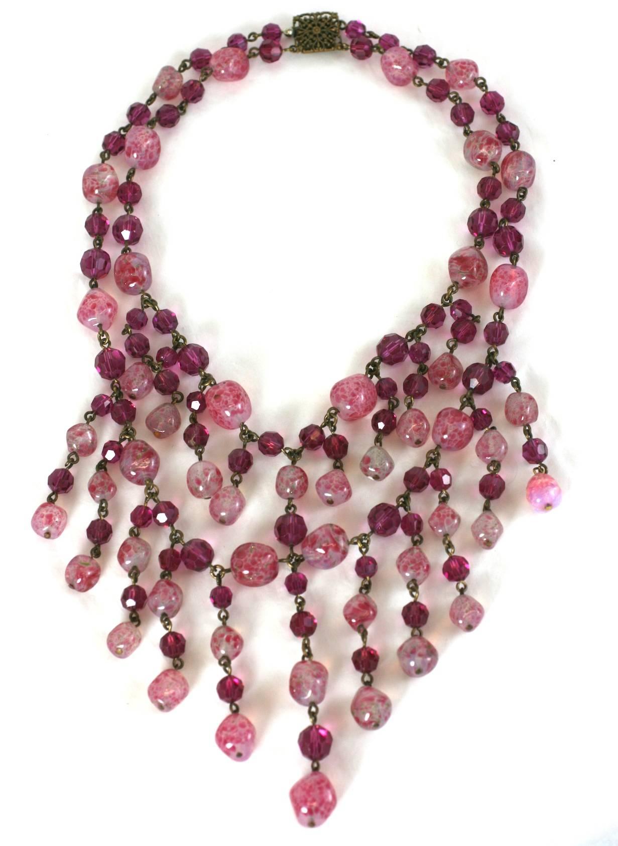 Elegant Louis Rousselet draped bib necklace of faceted fuschia crystal beads, mixed with handmade mottled rose quartz pate de verre beads. Made in France. France 1950's. Excellent Condition
Length 16.50