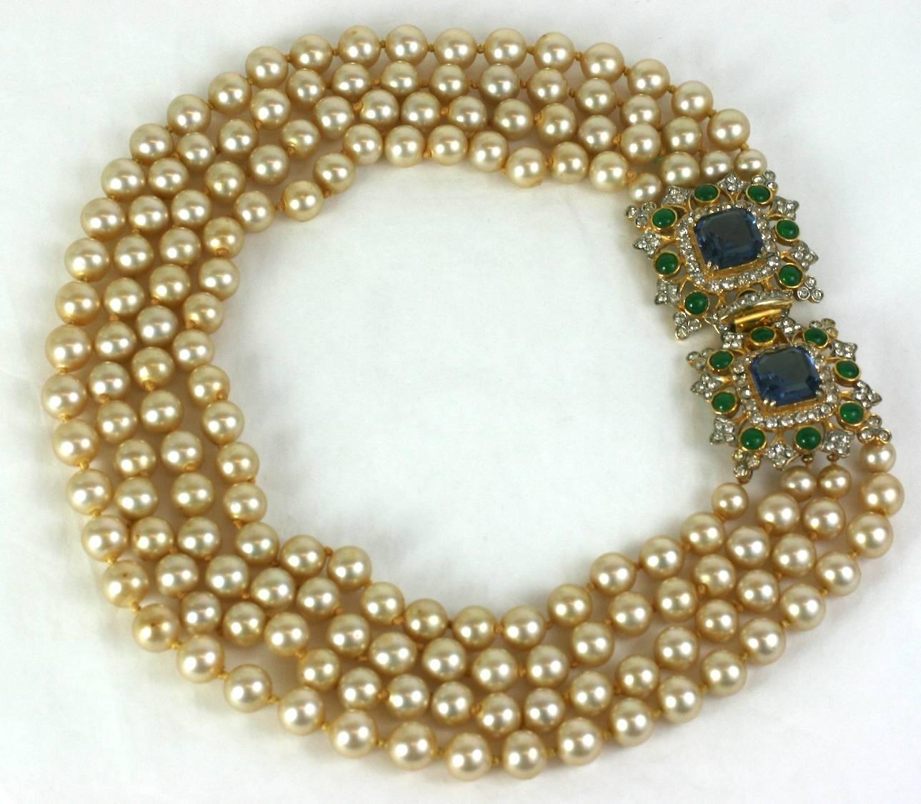 Glamorous Kenneth Jay Lane, Laguna multi strand faux pearl necklace with elaborate jeweled clasp of faux sapphires and emeralds in the style of David Webb. 1960's USA. 
Shortest length 16
