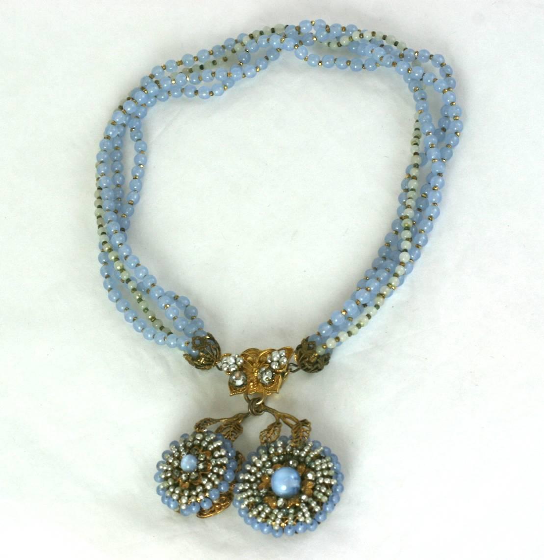 Miriam Haskell multi strand faux white and blue moonstone pate de verre bead necklace. Russian gilt butterfly clasp closure with intricate double flori form pendant of hand sewn, faux seed pearls and faux moonstone beads.
Excellent Condition.