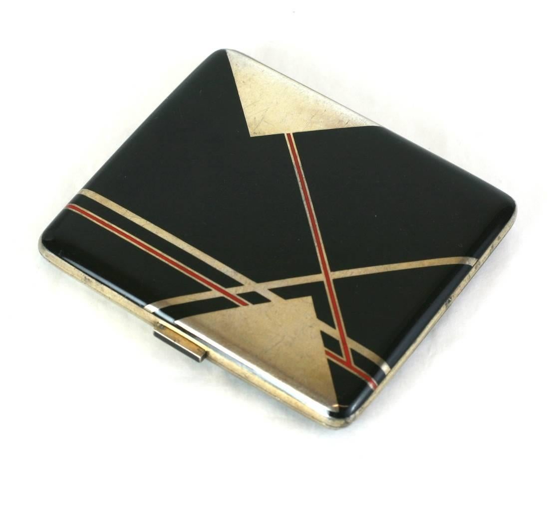 Art Deco Austrian enamel case circa 1920, of sterling silver with red and black hard enamel in a high style Cubist design. The negative triangular areas are the sterling base of the case. The fitted interior is gold washed.
Marked, 