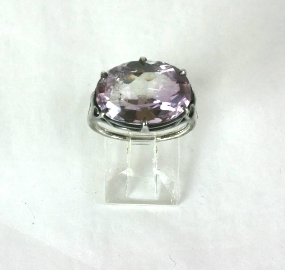 Elegant and unusual Art Deco Amythest Ring with natural color zoned stone. We love this elegant ring for many reasons, especially the East-West mount. 
The large oval amythest is beautifully faceted and has bands of soft purple to clear with some