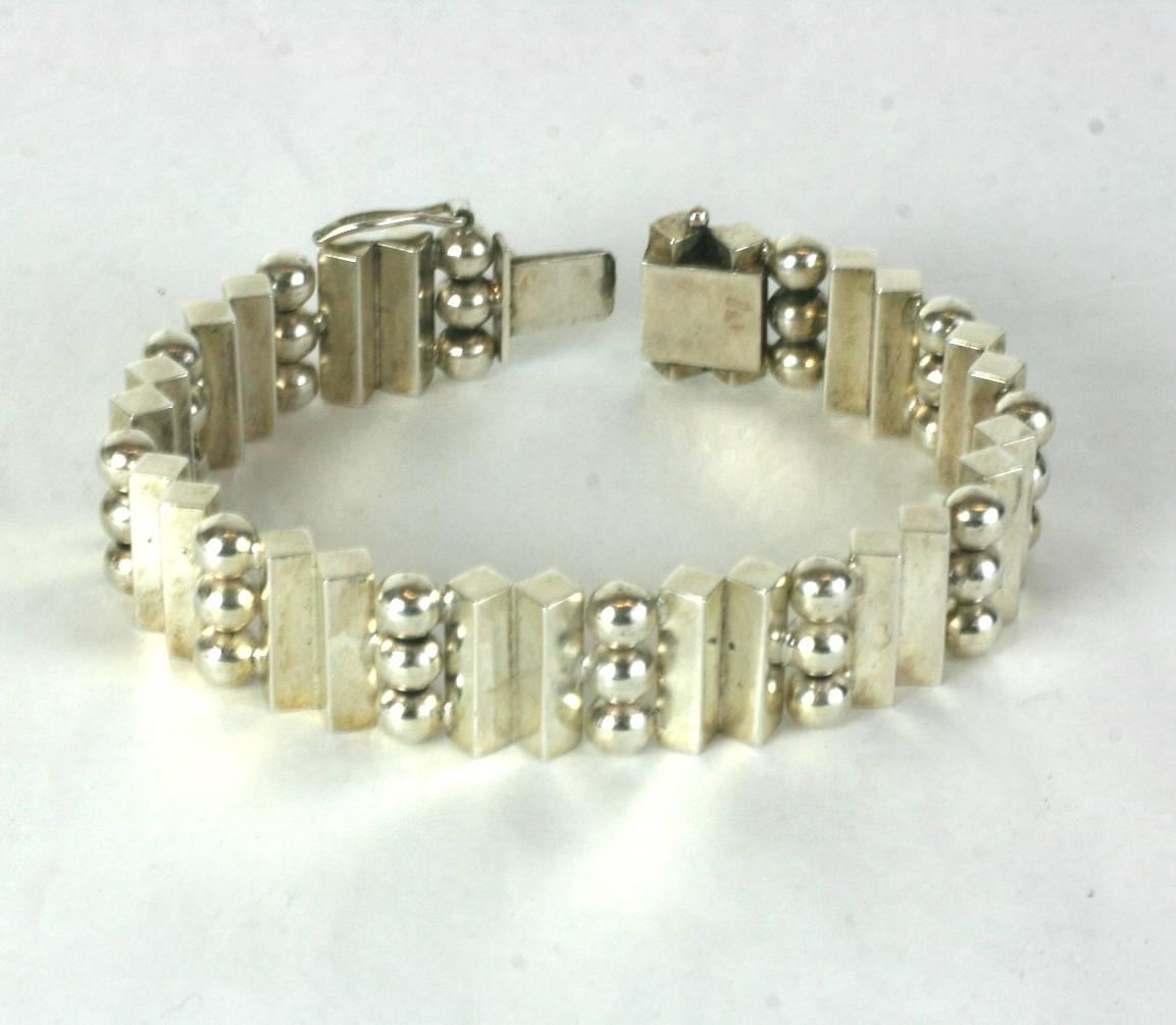 Unusual Architectural Art Deco Silver Bracelet of European origin. Extremely beautiful construction and design. 
Solid silver bars are set on edge in an Art Deco design spaced with triple ball spacers. The spheres actually hide the hinges which