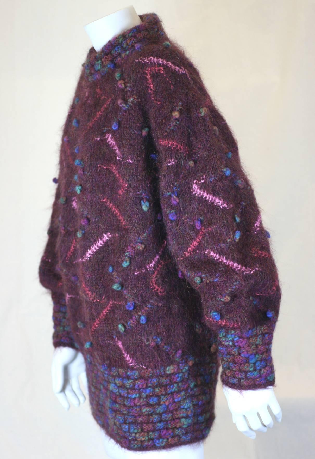 Burberry Berry Handknit Popcorn Knit in deep wine with multicolored decoration and poms poms.  Deep collar, cuffs and hem knit. Handknit, oversized 1980's UK. 100% Wool. Size 1 UK.
Length 28