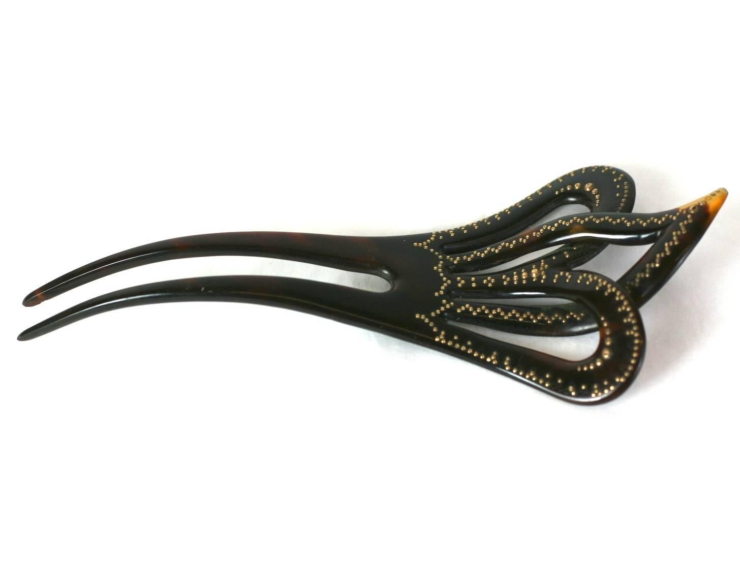 Victorian Tortoise Pique Comb from the late 19th Century. Hand carved tortoiseshell with finely applied gold accents. Lovely quality with interesting under carving of tortoise shell to create the dimension between the 3 lobes. 
Excellent condition.