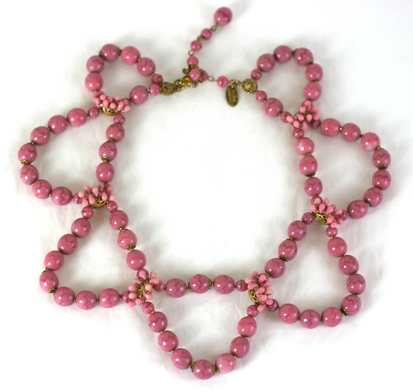Miriam Haskell swag necklace of puzzle patterned handmade dusty rose pate de verre round beads. Each swag is separated by Russian Gilt filigrees hand sewn with micro dusty rose glass tear drops.  1950's USA.  
Excellent Condition. 
Length 12.25 