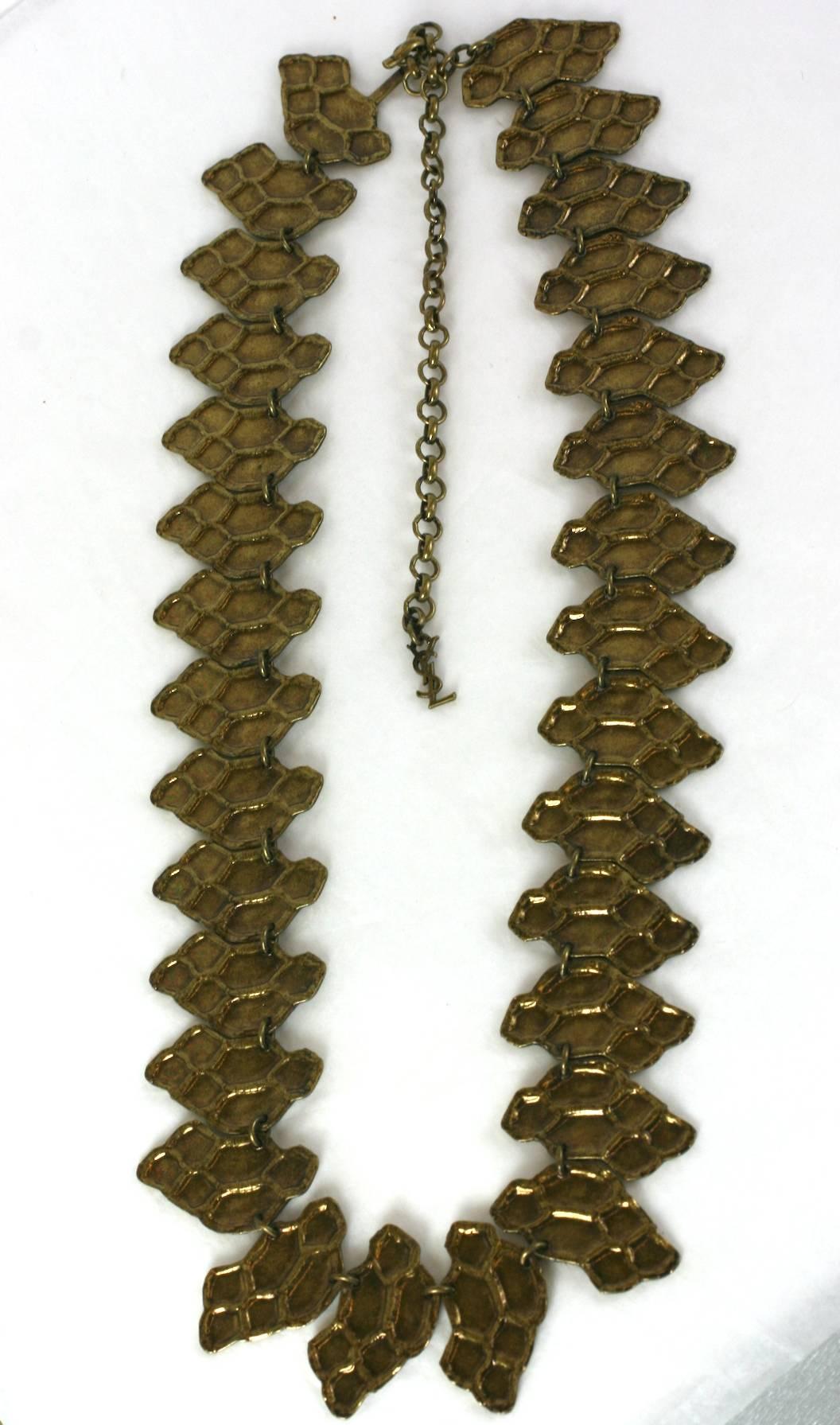 Yves Saint Laurent Alligator textured gilt bronze link belt, made by Robert Goossens , as patches of torn alligator skin.
Excellent Condition.
Length 26