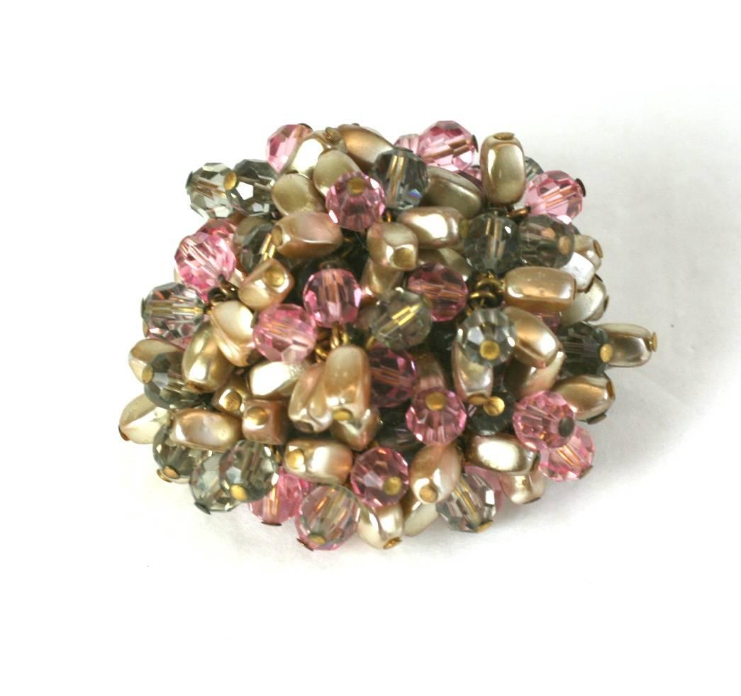  Roger Jean- Pierre cjewled depose cluster clip brooch of faux pearls with smoke and pink crystal faceted beads. The melange produces an almost  flori form design. Brooch clip is very dimensional, almost a half dome studded with striking beads.