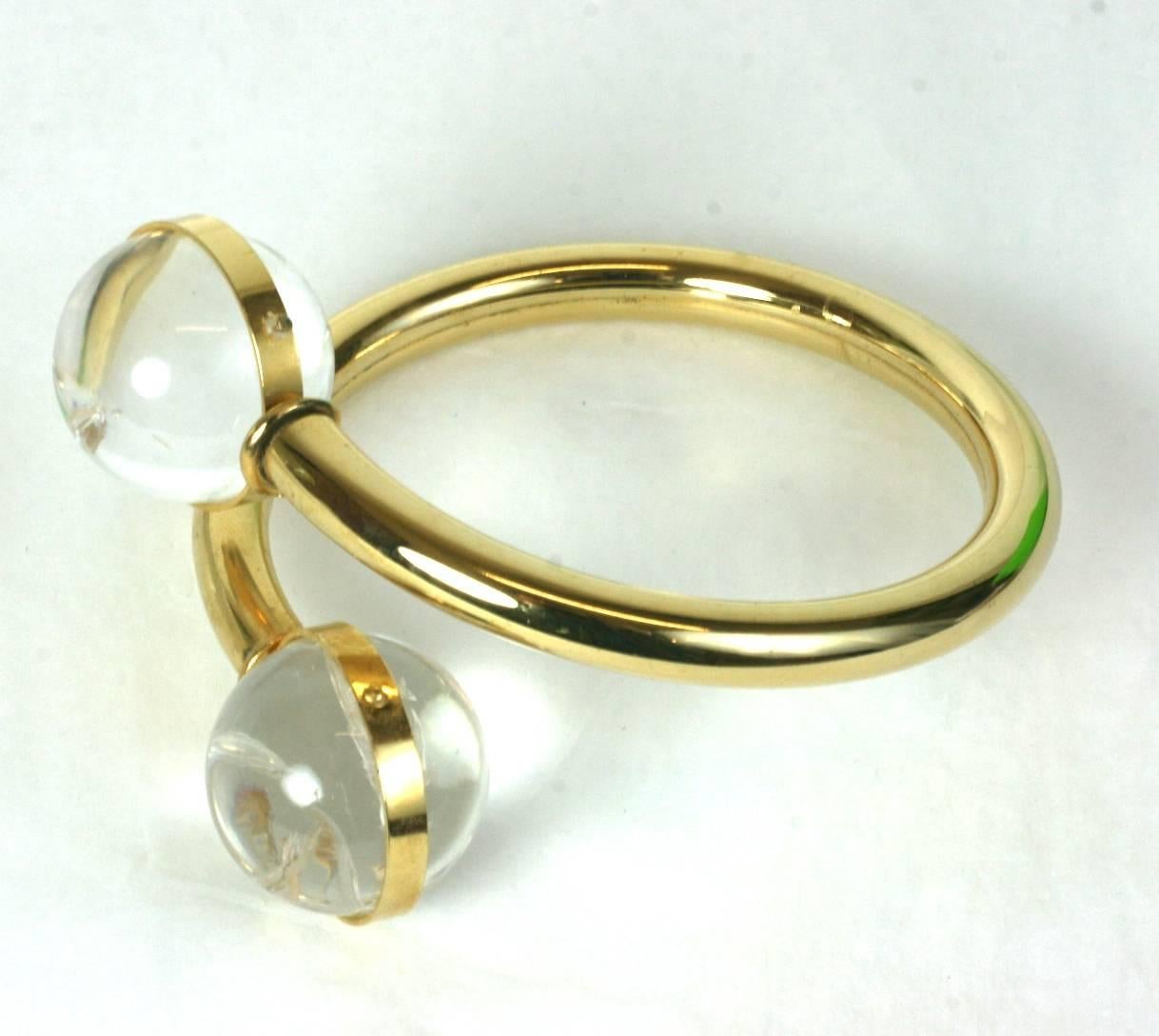 Lucite ball bypass bangle with spheres on the terminals of the gilt tube bracelet. Large and striking with a band of gilt metal holding each sphere. 1980's USA.
Excellent condition. Large size. 
Interior diameter 2.5