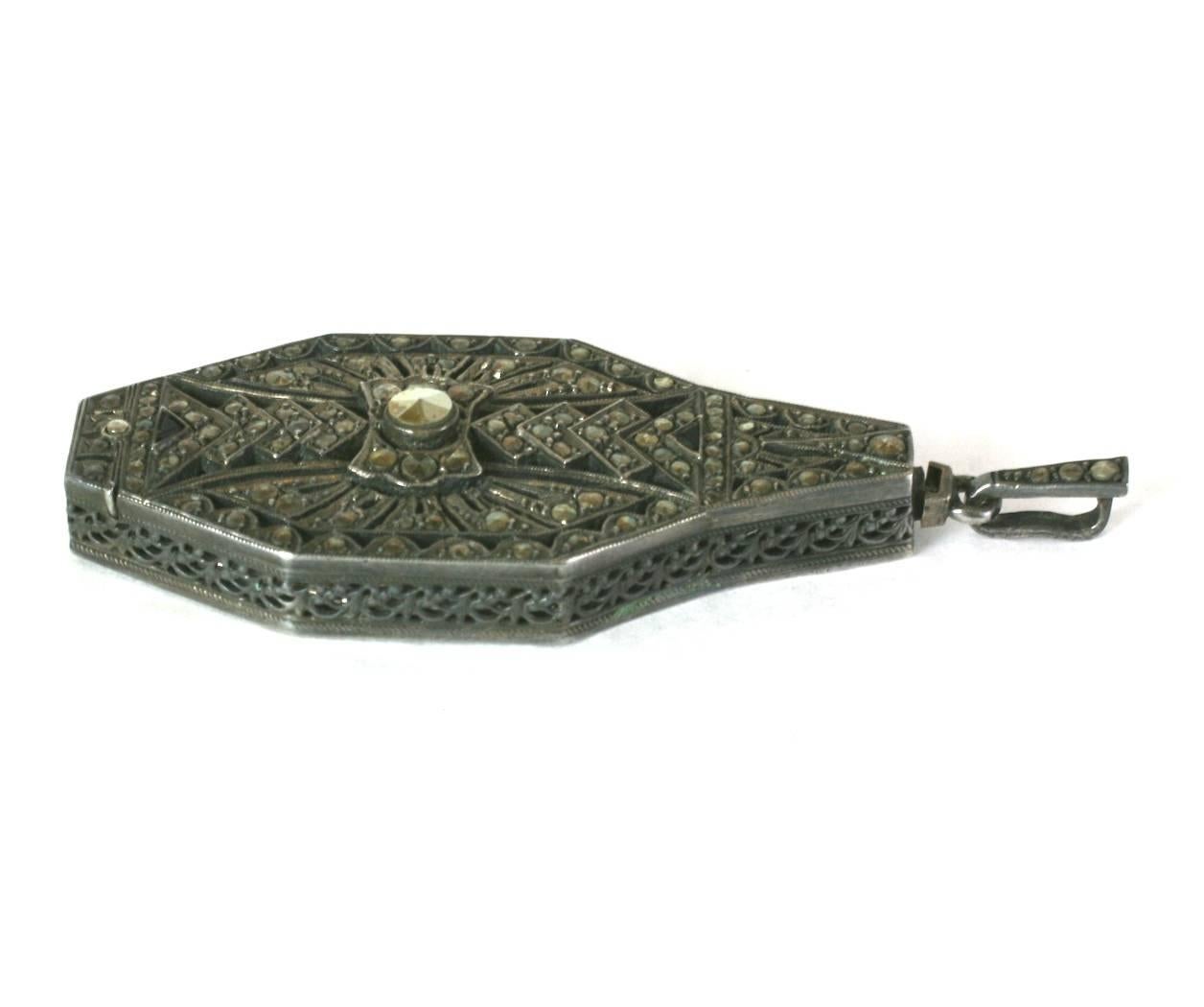 Art Deco finely detailed marcasite on sterling silver lorgnette pendant. Glasses (magnifier) flip out when pendant bail is gently pulled upwards. German Touch Marks for silver content.  Excellent Condition. 1920's Germany. 
Length  2.6