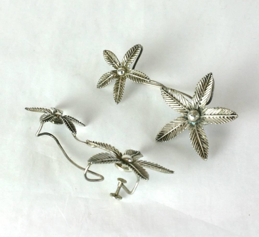 Amazing Sterling Floral Ear Cuffs from the 1950's. Handmade by a jeweler with floral castings in 2 sizes that go up the ear. Screw back fittings anchor large flower to ear lobe and the wire fitting above secures the top of the earring onto the ear.