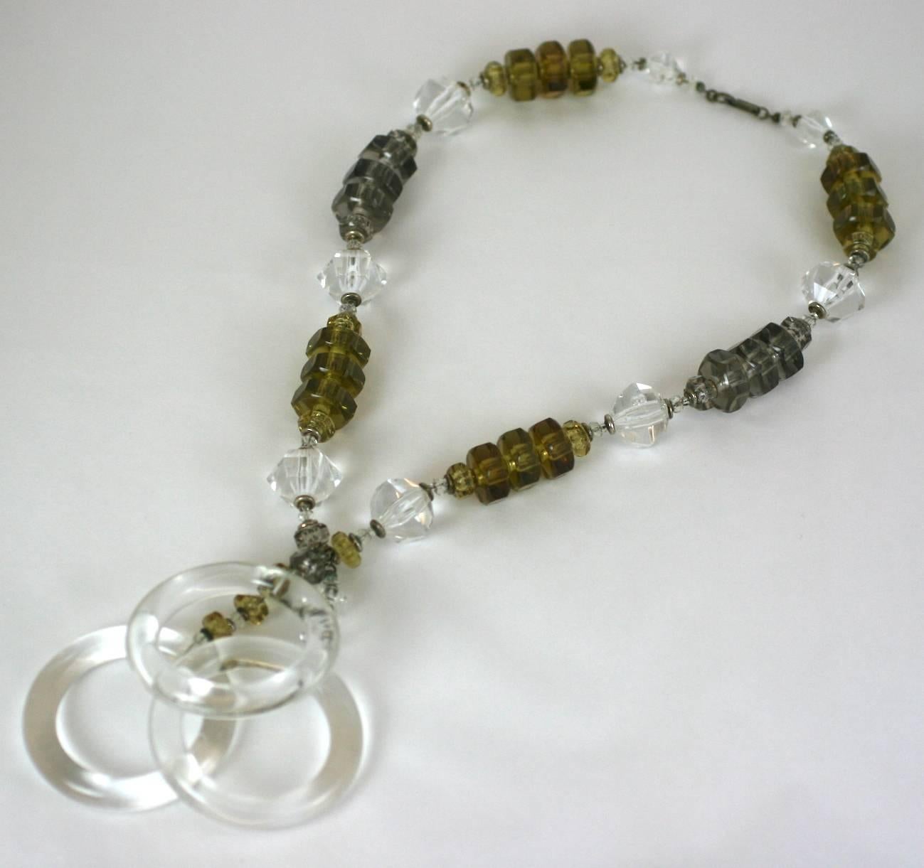 Miriam Haskell Multi Lucite Ring Pendant Necklace from the 1960's. Crystal lucite rings hang from a necklace composed of faceted lucite beads in smoke, crystal and olive. 1960's USA.
Excellent condition.
Necklace measures 22