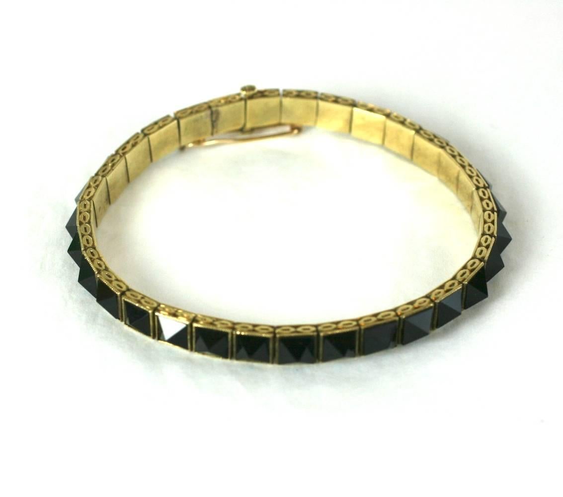 Art Deco Punk Straight Line Bracelet from the 1930's. Unusual pyramidal cut onyx stones are used in this Art Deco bracelet. These stones were much more prevalent in the late 19th Century but the effect is very cool and modern. 
These types of liquid