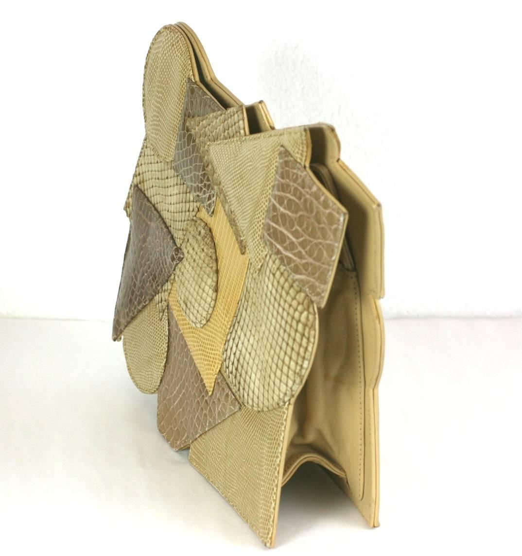Carlos Falchi Pieced Snake and Calf Bag in an applied Cubist design. Varying alligator and snakeskin forms are patched onto the front. The form of the bag is then created by this design. 
A shoulder strap can be folded into the clutch. Striking and