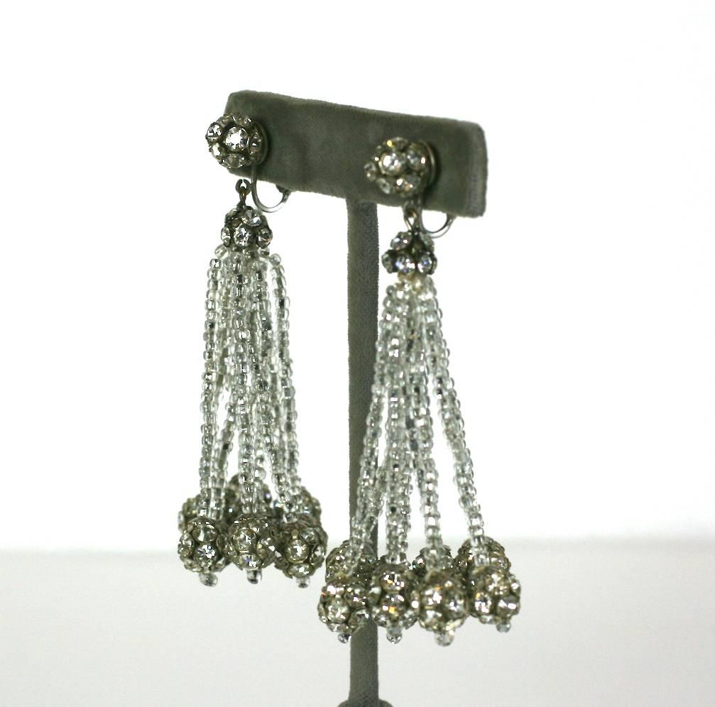 Vogue Seed Bead and Pave Ball Tassel Earrings with clip back fittings from the 1960's. A tassel of silver lined crystal seed beads is ended in pave crystal balls. 
A pave ball and cap are on the ear. 3.25