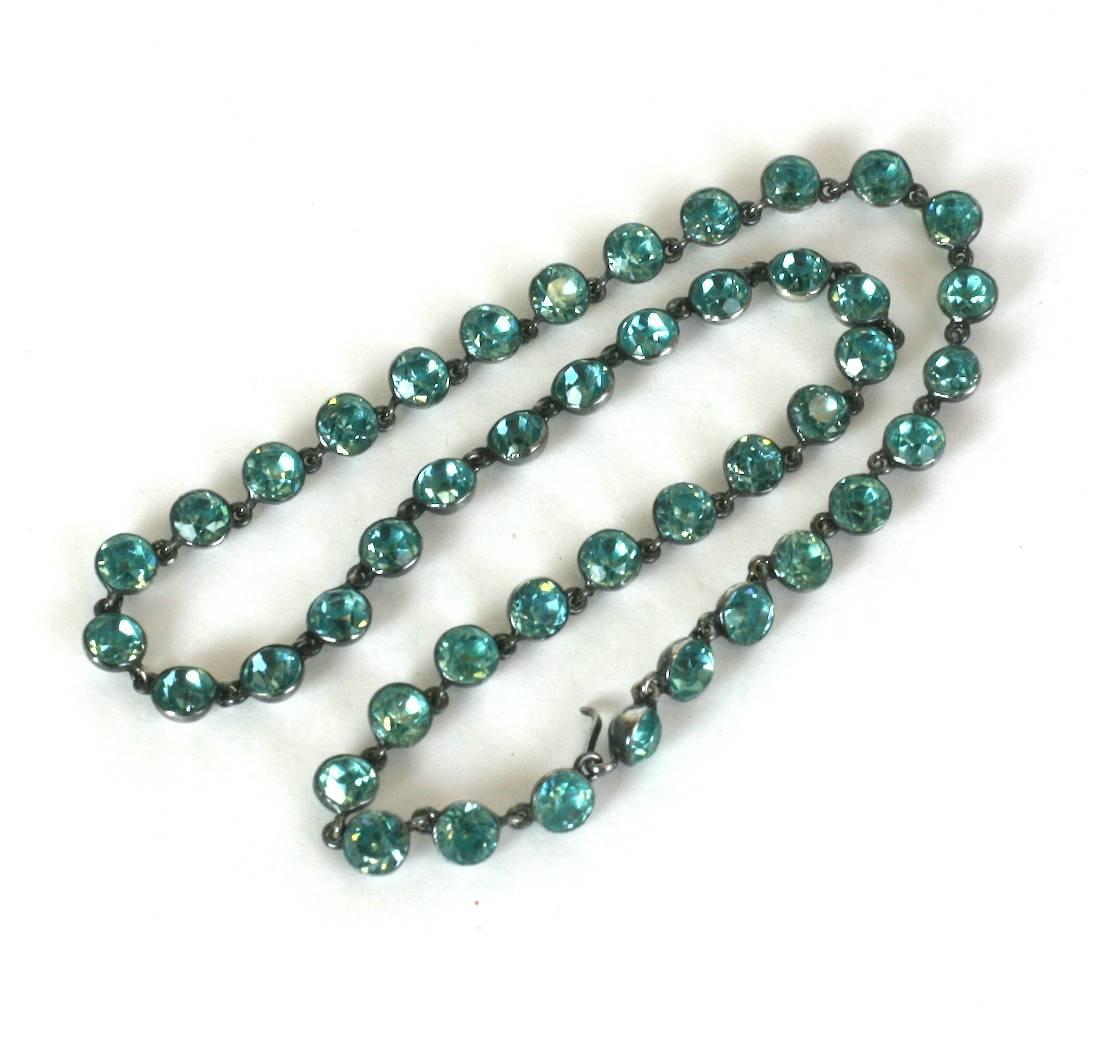 Paste necklace from the late Victorian era with faux blue zircons in closed back half round sterling silver settings. The foiled back pastes offer a delicate and subtle touch of the distinctive greenish blue tone particular to zircons. High quality