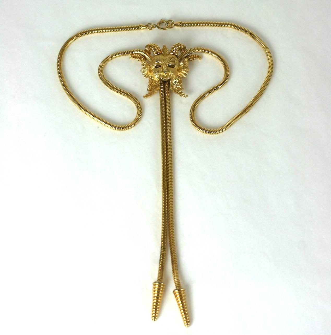 Trifari Fanciful Bolo Style Necklace with a horned mask figure pendant. The gilt motif is fixed on the necklace and does not slide. 1970's USA.
Necklace 19