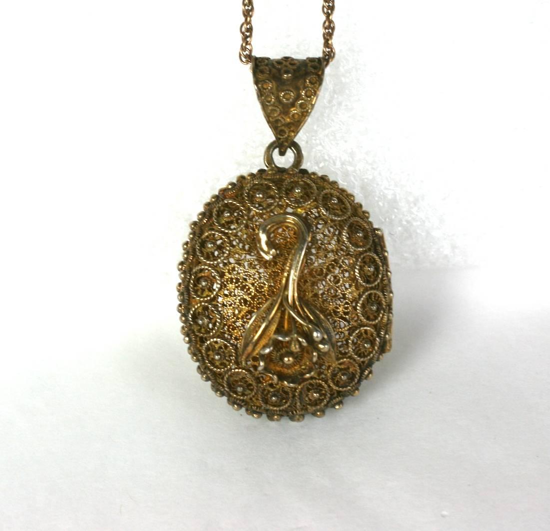 Victorian Silver Gilt Filigree Pomander Locket circa 1880's. One side has an inverted posy, and the other has a Maltese cross. The openwork filigree locket can hold a perfumed cotton for scents. Likely Spanish, late 19th Century. Gilded silver. Gilt