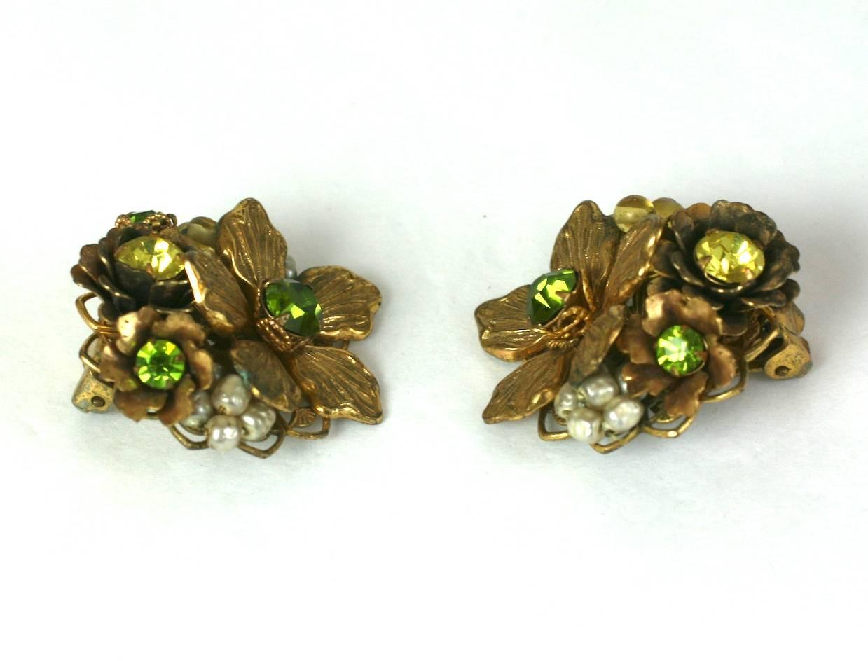 Striking De Mario gilded flower bouquet ear clips of faux green tourmaline and citrine crystals with hand wired faux baroque pearl accents. 1950's USA. 
Excellent Condition. 
Length 1 1/2"
Width 1 1/8"