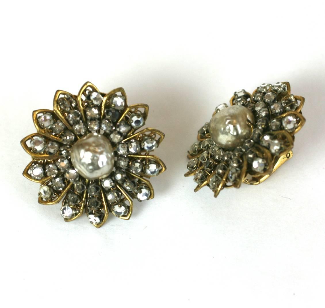 Miriam Haskell Floriform Earclips of signature faux baroque pearls and hand sewn crystal rose montes set onto Russian gilt filigree. Early horseshoe signature. Clip back fittings. 1940's USA. 
Ex. collection of fashion icon, DD Ryan. Excellent