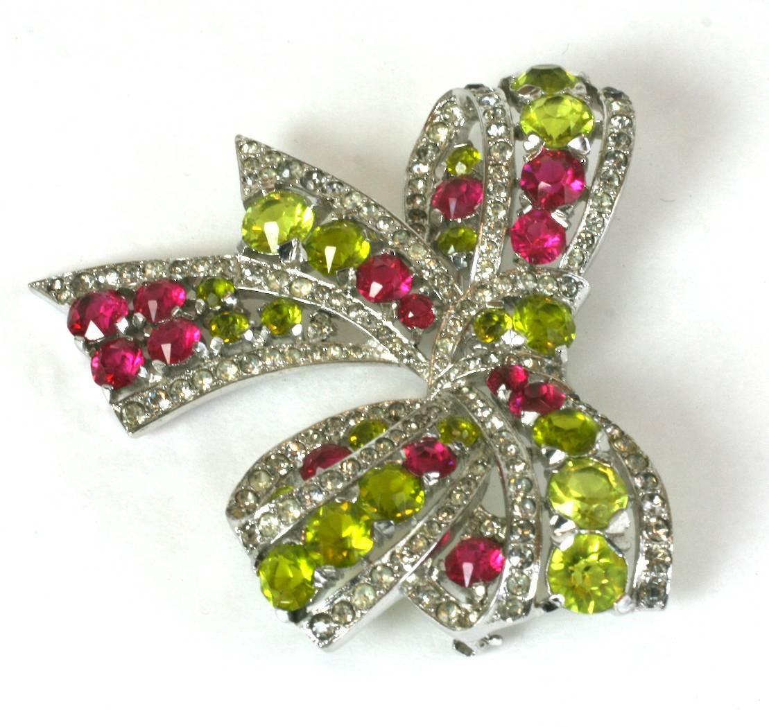 Exceptional Marcel Boucher Art Deco pave crystal, faux ruby and faux demantoid green garnet bow brooch. Lovely, unusual combination of colors for the period with a large, striking scale. High quality Rhodium finished metal, Marked: MB (phrygian