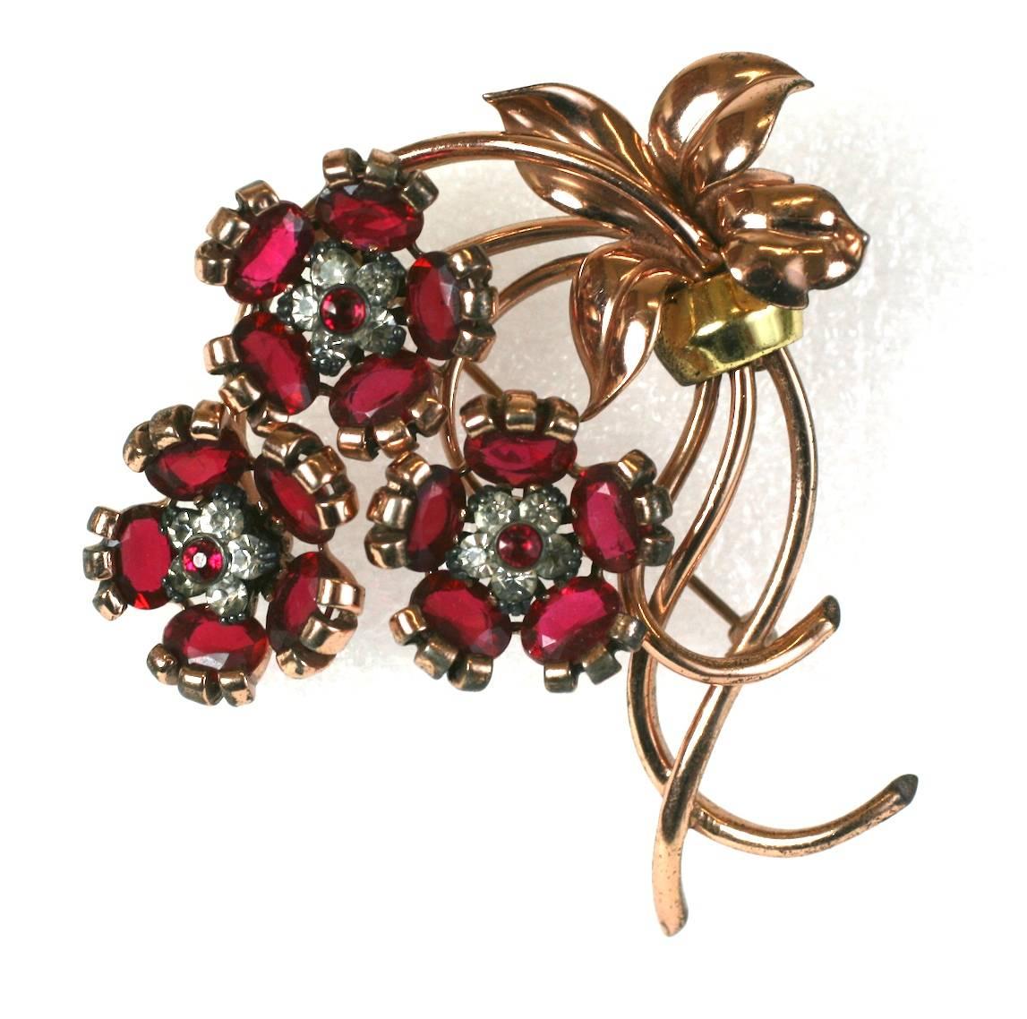Wonderful Pennino Retro rose gold washed sterling silver, triple faux ruby floret and leaf cluster brooch of faceted oval stones, bullet cabochons centers and crystal pave accents.  Excellent Condition. Large and dimensional design.  1940's USA.