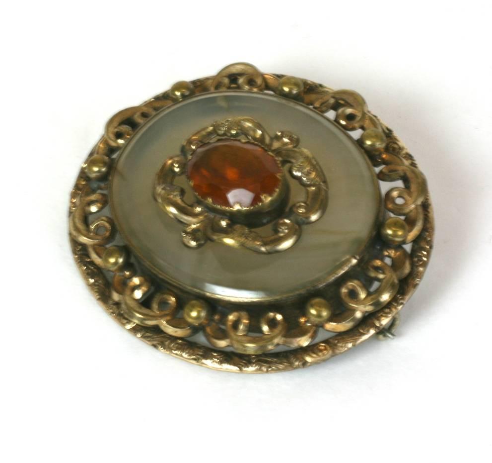 Large and attractive Victorian Agate Brooch with central foil backed citrine paste. Coiled ornate filigree work in gold filled metal. 
1880's UK. Excellent condition. 
2.5