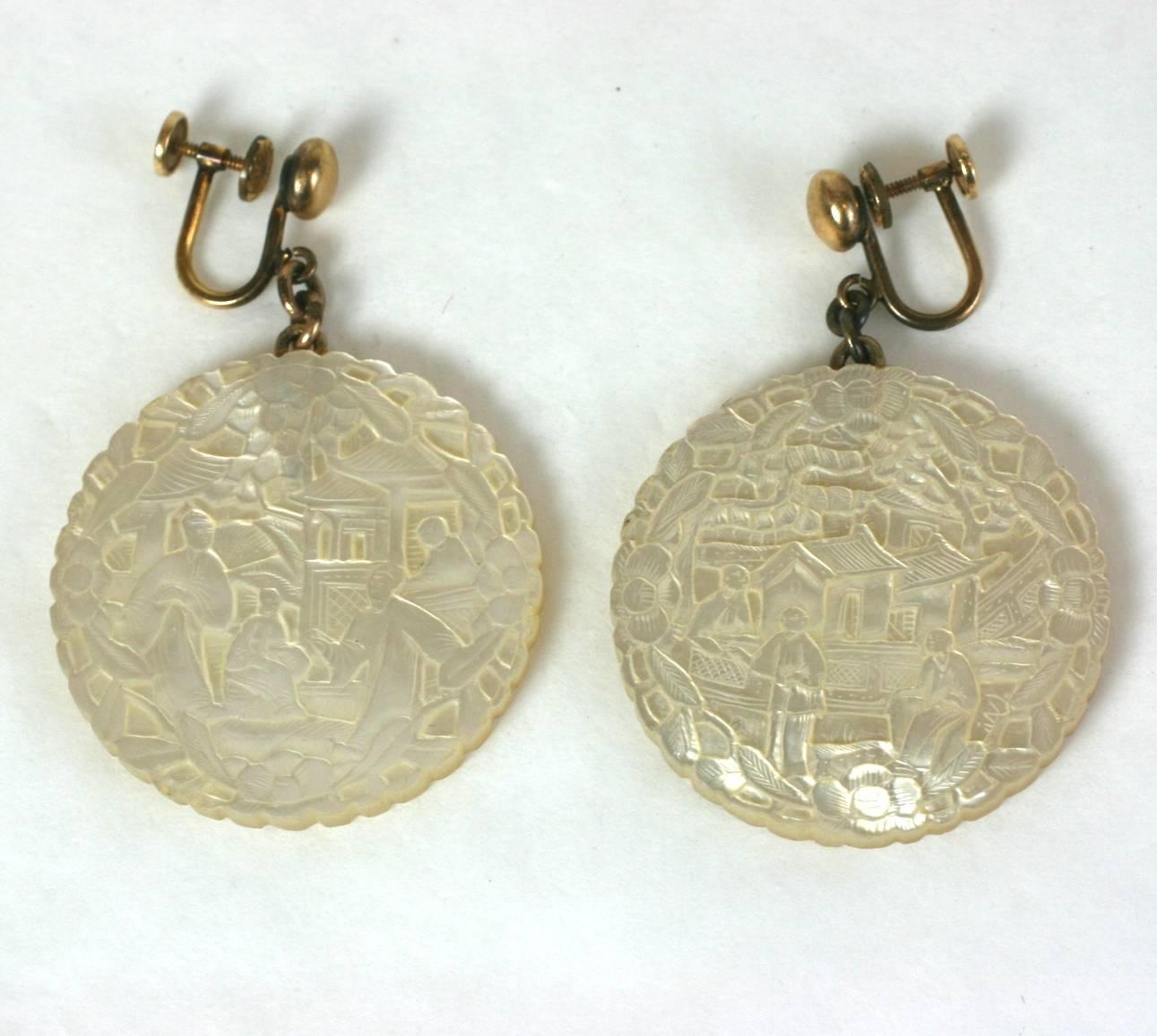 Mother of Pearl Chinese Earrings made from 19th Century antique gaming chips. Meticulously rendered scenic carvings with enameled "S" on the back of each chip. 
Chips are mounted onto gold filled screw back earring tops, at a later date .
