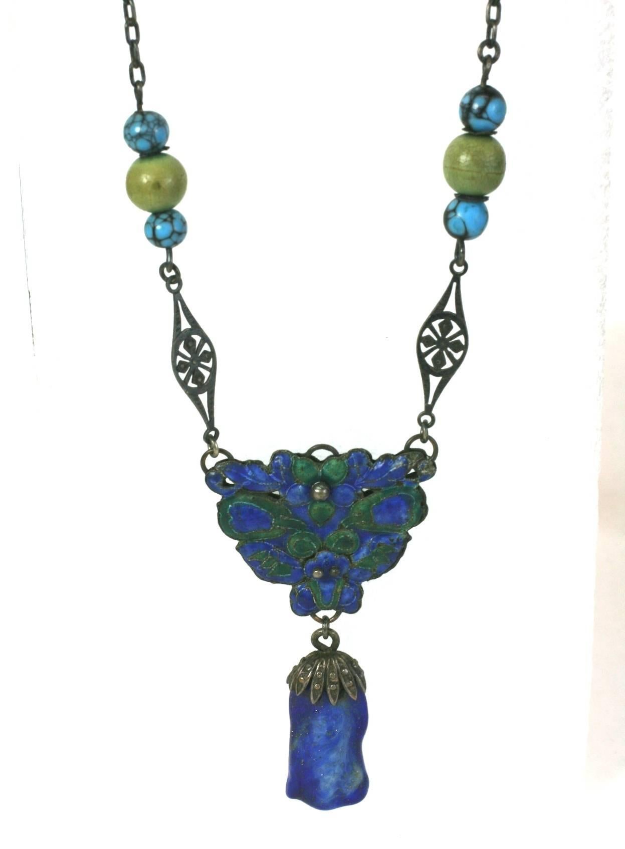 Antique Chinese Enamel and Lapis Glass Necklace of silver circa 1900's.  Central motif enameled in green and blue with lapis pate de verre drop. Faux turquoise and hardstone beads on chain. 
Small size 14