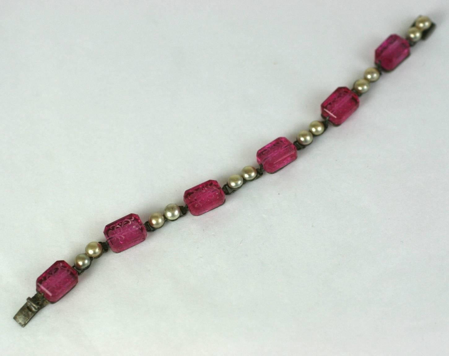 French Art deco faux ruby pate de verre intaglio etched rectangular stone and faux button pearl link bracelet. Stamped Made in France. Excellent Condition. 
Length 6.50