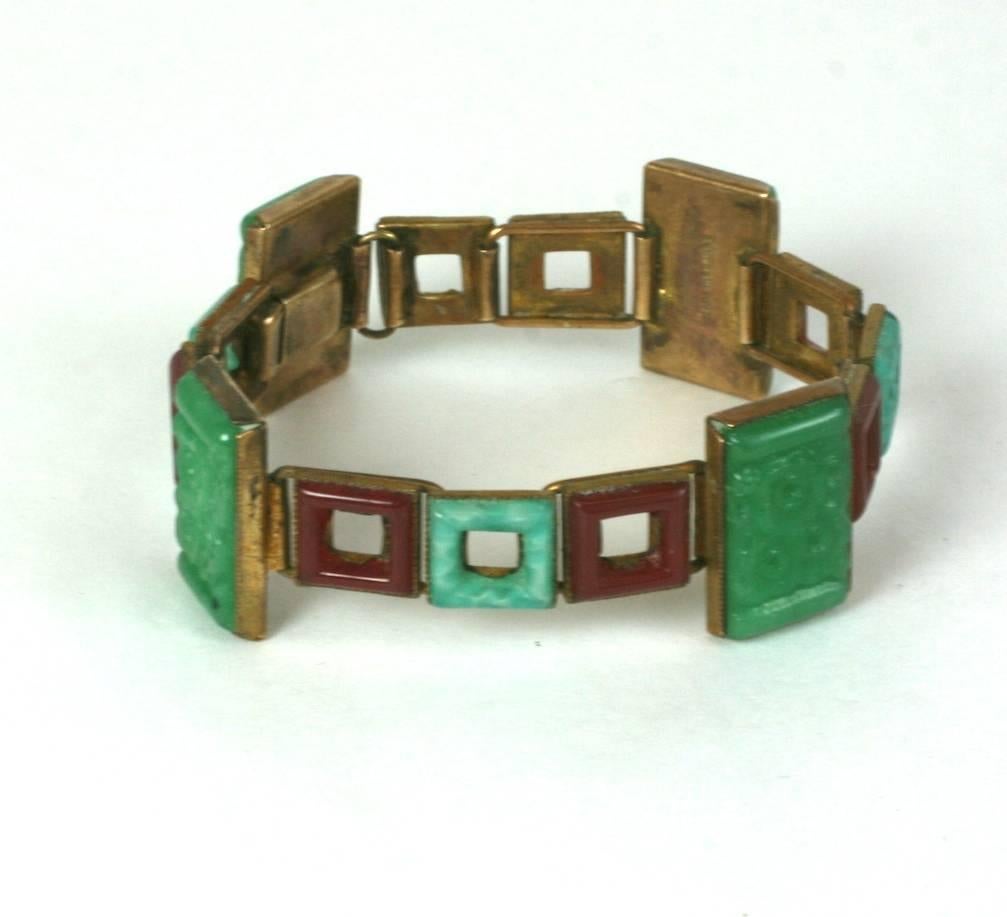 French Chinoiserie Art Deco articulated link bracelet of faux jade rectangular carved panels with square rings of faux amazonite and carnelian molded pate de verre glass.  1920's France. 
Stamped, Made in France.  Excellent Condition.
Length