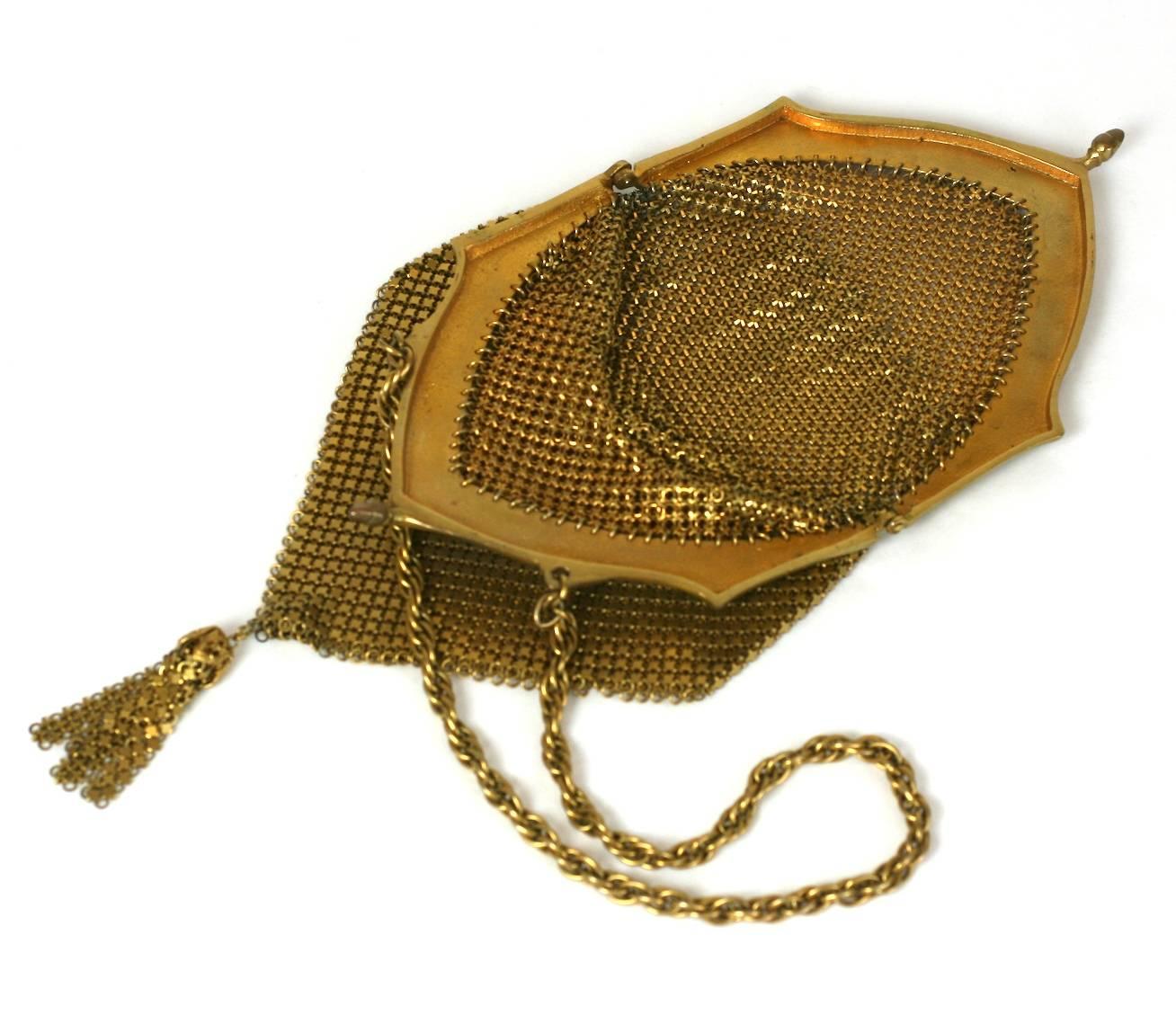Lovely Art Deco Brass Mesh Dance Purse with mesh tassel. Ornate foliate filigree decoration runs up both sides of the frame. Acorn "kiss" clasp closure. 1920's USA.
Excellent condition. 
10.5" x 4". Chain 14". 