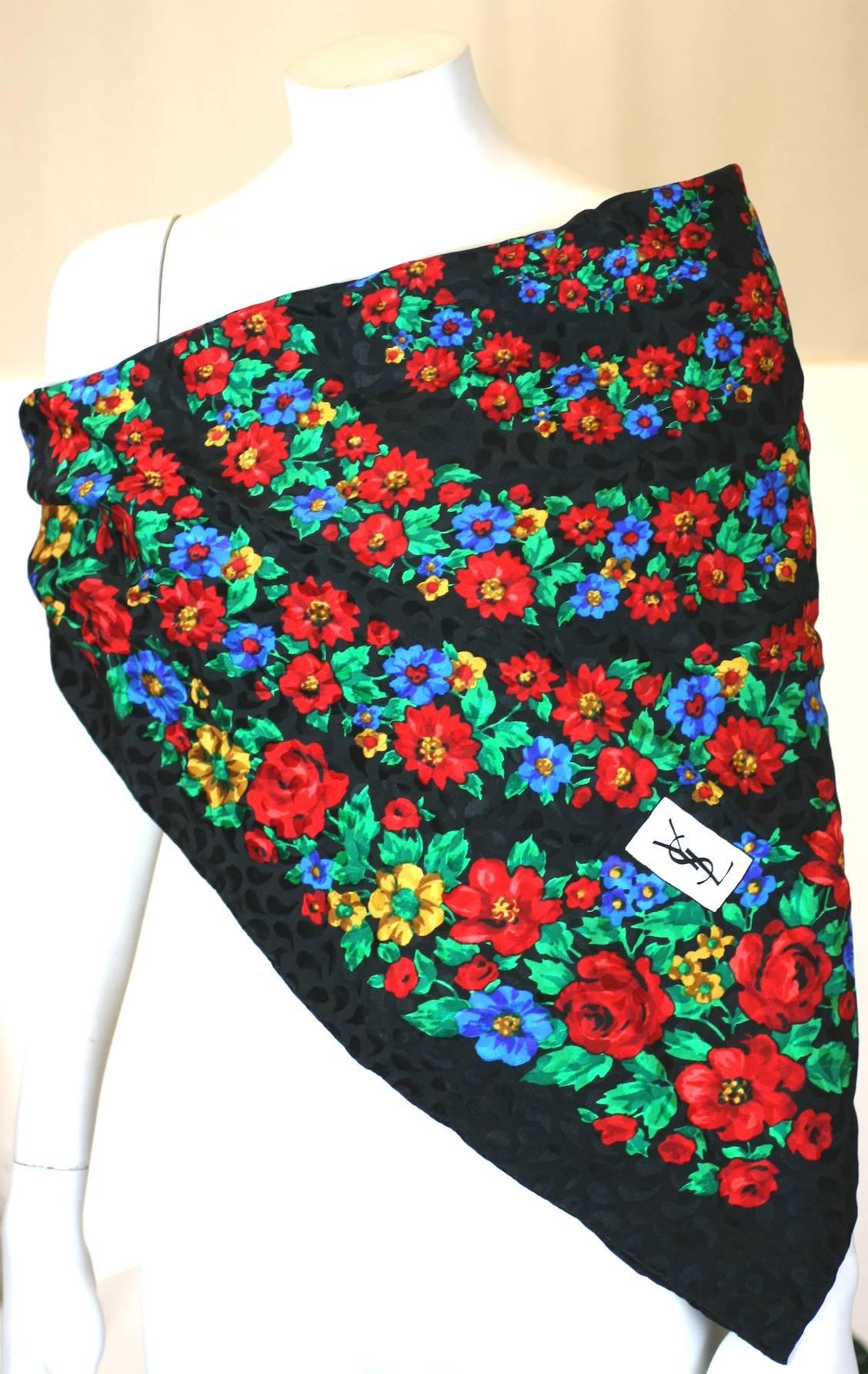 Yves Saint Laurent Russian inspired floral printed silk square scarf. Concentric circles of multi color flowers on a black ground. Excellent Condition.
L 32"
W 32"

