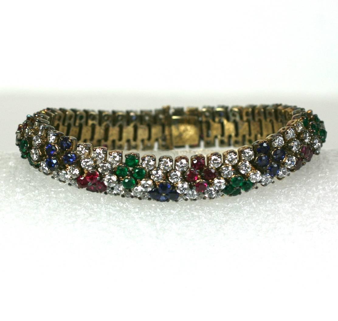 Jolie Gabor faux gemstone bracelet, of gold washed sterling silver, and faux diamond crystal paste with faux ruby, sapphire and emerald stones. Wonderful, high quality copy of fine jewelry. 
Provenance: Collection of Bunny Mellon. Excellent